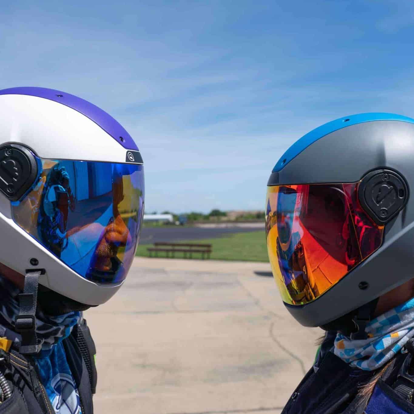 Two skydivers wearing Cookie helmets standing and looking at eachother