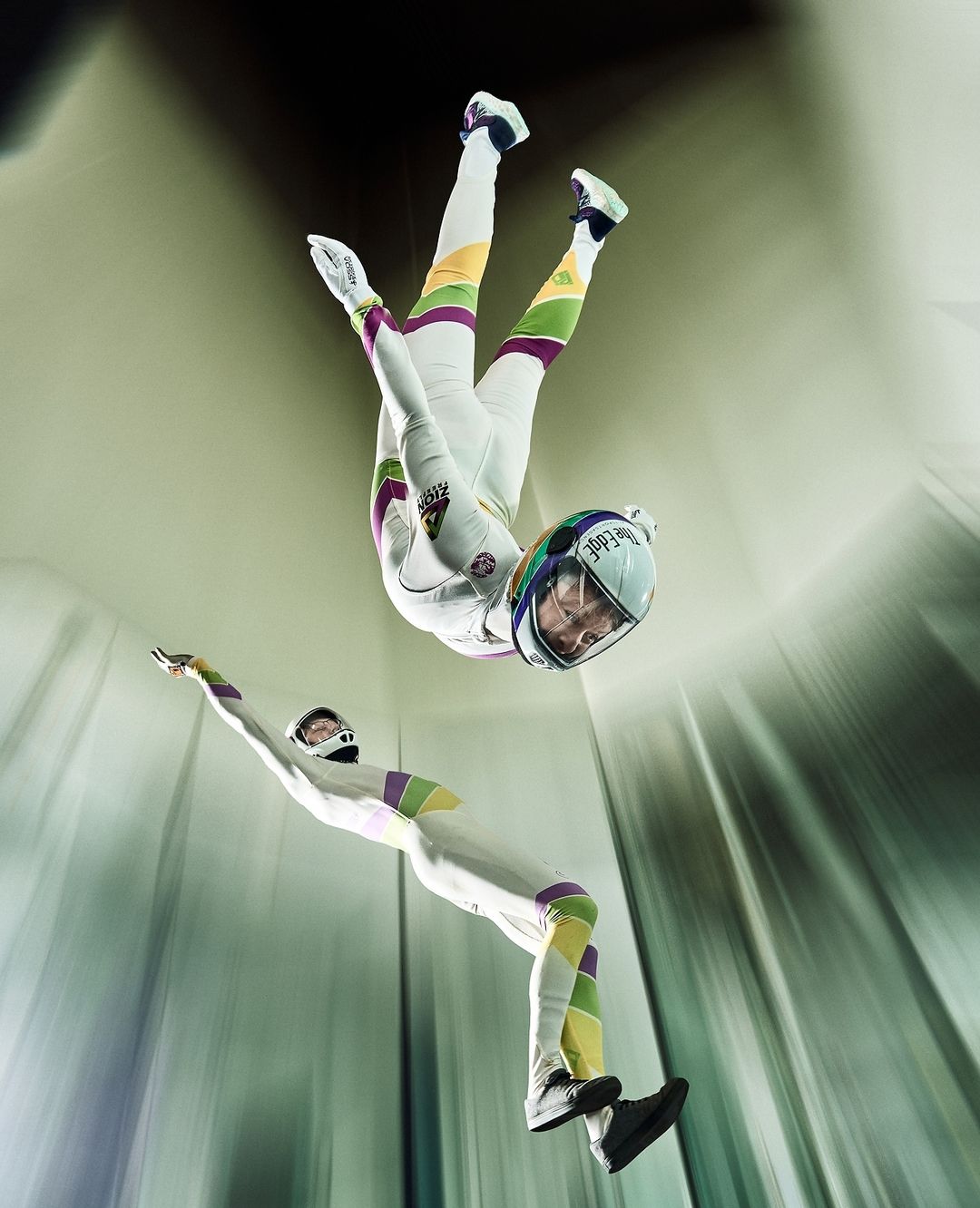 Tunnel fliers in white jumpsuits wearing Cookie helmets